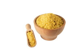 Savoury vegan yeast flakes in wooden bowl and scoop isolated on white background.