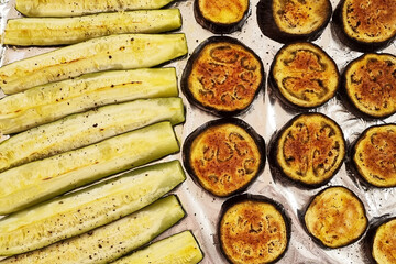 Roasted eggplant and zucchini on a baking sheet. Top view. Food.
