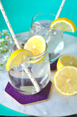 Lemon Water with Fresh Slieced Lemon on Background