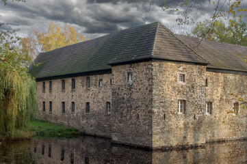 the moated castle Haus Graven (around 1300) in the Wiescheider Wiesen,part of the Bergische Heideterrassse,Langenfeld-Wiescheid,North Rhine-Westphalia,Germany