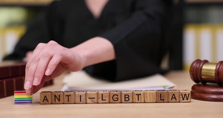 Judicial symbols of change emerge as a judge reviews anti-LGBT laws with contrasting colors of hope and discrimination - Powered by Adobe