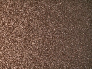 Fototapeta premium Abstract bronze metallic texture with reflective surface and fine shimmer, perfect for backgrounds, design materials, or decorative projects.