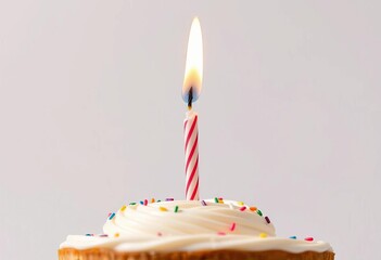 Close-up of a birthday cake candle being blown out against a white background,  sprinkles,  vibrant