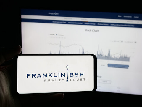 Stuttgart, Germany - 10-30-2025: Person holding smartphone with logo of US company Franklin BSP Realty Trust Inc. on screen in front of website. Focus on phone display.