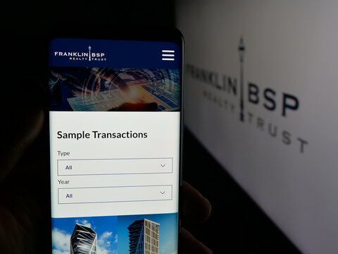 Stuttgart, Germany - 10-30-2025: Person holding cellphone with webpage of US company Franklin BSP Realty Trust Inc. on screen in front of logo. Focus on center of phone display.