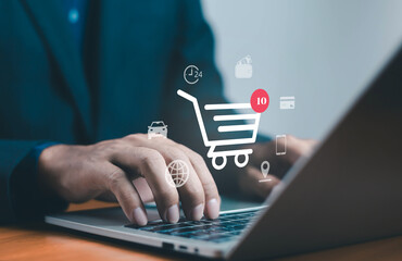 Businessman typing on laptop with online shopping cart icon, symbolizing e-commerce, digital marketing, online payment, and global internet business concept for modern technology and retail innovation