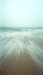 Vintage image of ocean waves reaching the beach with a motion effect