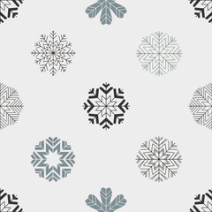 Seamless pattern with snowflakes in gray and black on a white background.