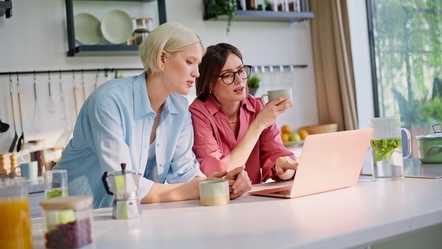 Lesbian woman supporting girlfriend embracing at kitchen closeup. Lovely girls - Powered by Adobe