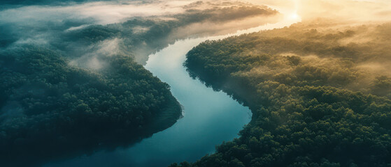 Fototapeta premium Aerial view of winding river flowing through dense forest with morning mist and sunlight, scenic natural landscape symbolizing tranquility, wilderness, and environmental beauty 