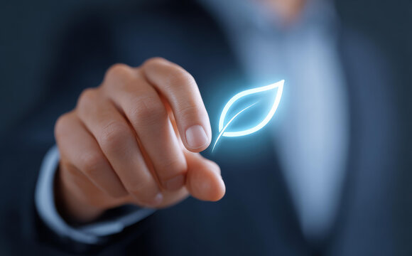 Focused businessman with glowing blue leaf icon on finger. Symbol of green energy, technology, sustainability, and future innovation for clean eco environment and growth
