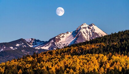 Snow-capped mountain with full moon above peak, surrounded by autumn forest in vibrant orange and yellow under clear blue sky for editorial nature photography seasonal decor and poetic alignment-theme