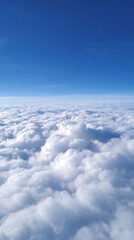 Serene and peaceful aerial view of white fluffy cloud above atmosphere. clear blue sky and bright weather create sense of calm and freedom during air travel