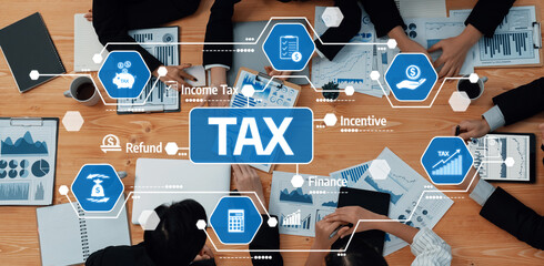 A collaborative business meeting focused on tax planning, showcasing financial charts and data...