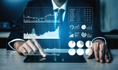 A businessman in a suit analyzes financial data on a tablet, surrounded by digital graphs and charts, reflecting modern data analysis in a corporate environment. Impute