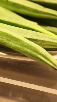 Delicious and healthy vegetable ladies finger also known as okra or bhindi displayed fresh and ready for sale at a market stall. Organic food rich in vitamins and nutrients