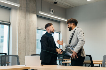 Business professionals shaking hands confirming partnership agreement