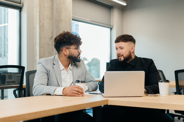 Diverse business team discussing plans in modern office