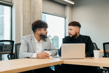 Two men discussing business in modern office