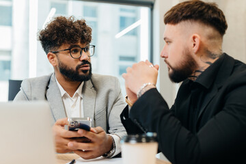 Two men discussing business in modern office