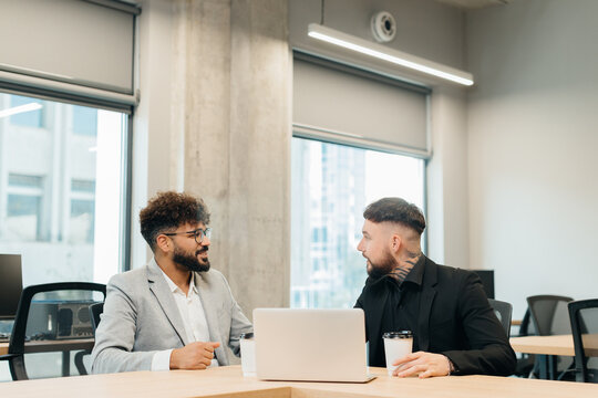 Diverse business professionals discussing work in modern office - Powered by Adobe