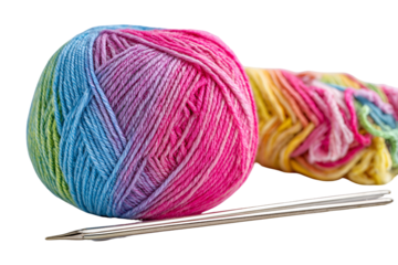 Vibrant rainbow yarn ball and knitting needles on a black background