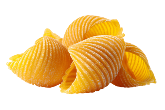 Pile of golden conchiglie pasta shells with ribbed texture on a black background