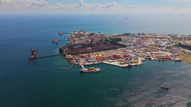 Drone footage of Labuan&rsquo;s Rancha-Rancha Industrial Estate, Malaysia, featuring Petronas methanol plant, oil and gas facilities, storage tanks, and offshore supply ships in clear tropical waters.