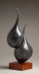 Abstract Sculptures, Two Dark Forms, Modern Art, Unique Design, Wood Base, Contemporary Style.