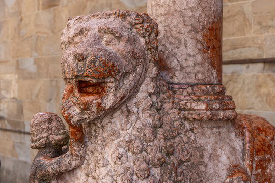 Close view of the pink Verona marble lion sculpture at Porta dei Leoni Rossi of the Colleoni Chapel in Bergamo Italy