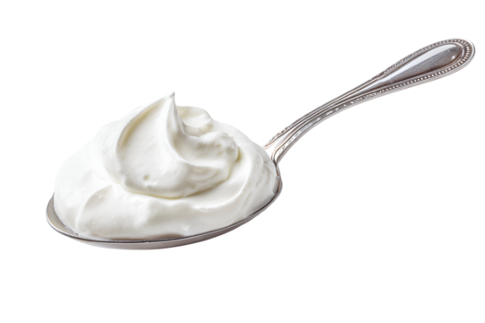 A spoonful of creamy white whipped topping or frosting on a black background