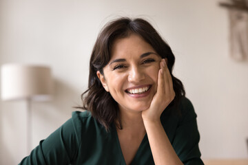 Headshot portrait beautiful young woman looking at camera with smile