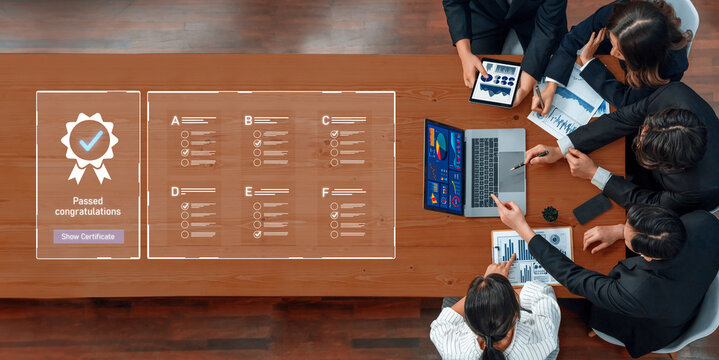 A diverse team collaborates around a table, discussing project achievements and visual data insights on laptops and tablets, celebrating success in a professional setting. Trope - Powered by Adobe