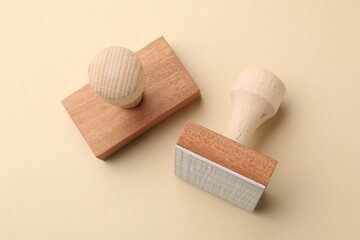 Two wooden stamps on beige background, top view