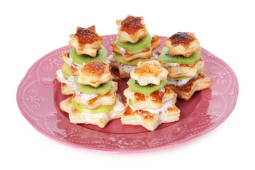 Sweet snacks made of puff pastry and slices of kiwi isolated on white. Christmas food