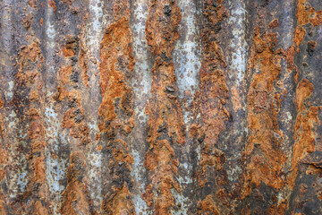 Rusty corrugated metal surface texture background. Old weathered iron sheet with an abstract grunge pattern. detailed decay and corrosion create rustic, industrial feeling