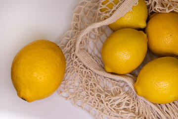 Eco Lifestyle with Lemons in Reusable Mesh Bag – Zero Waste Flat Lay on White Background