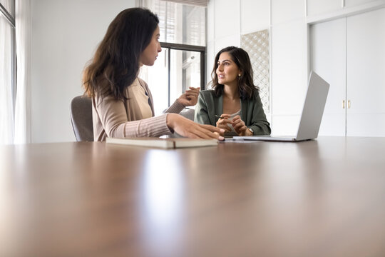 Two businesswomen having serious discussion in office
