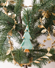 Handmade porcelain Christmas ornaments on a Christmas tree 