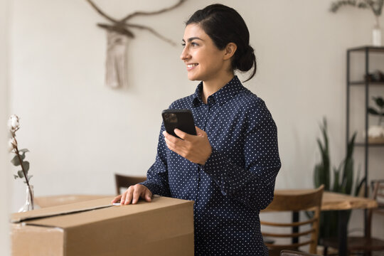 Smiling woman hold phone to shoot video about unboxing parcel