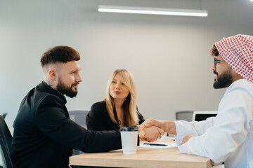 Diverse businessmen shaking hands closing global business deal