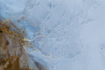 Aerial view of the earth's canvas painted with swirling turquoise and brown hues, sculpted by nature's artistry in geothermal Iceland, Geothermal Areas, Iceland.