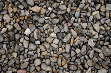 Natural stones background with mixed textures and colors.