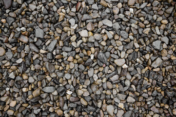 Natural stones background with mixed textures and colors.