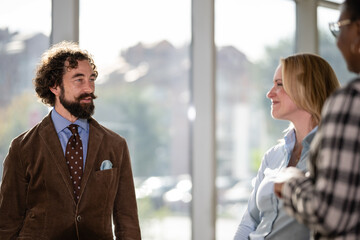 Business colleagues discussing work in bright office setting