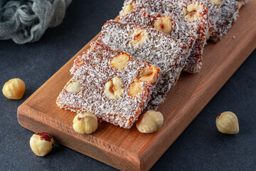 Turkish delight cezerye with pistachio or hazelnut on black background. Cezerye, a traditional dessert from the Mersin region