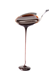 Melted chocolate or chocolate sauce dripping from a   spoon