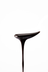 Melted chocolate or chocolate sauce dripping from a   spoon