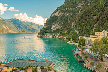 Sunset over Riva del Garda, Italy, with golden light reflecting on the lake, panoramic views of...