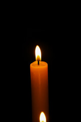 Lit candle flame glowing in dark, Christmas and Easter spiritual holiday concept